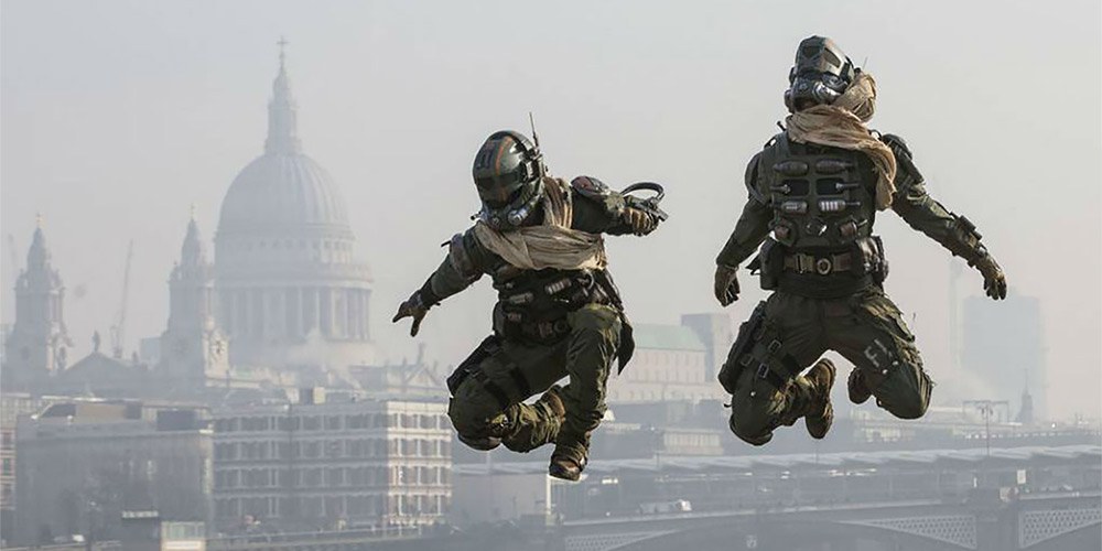 Two men dressed in Halo Masterchief costumes jumping with London landmarks in background