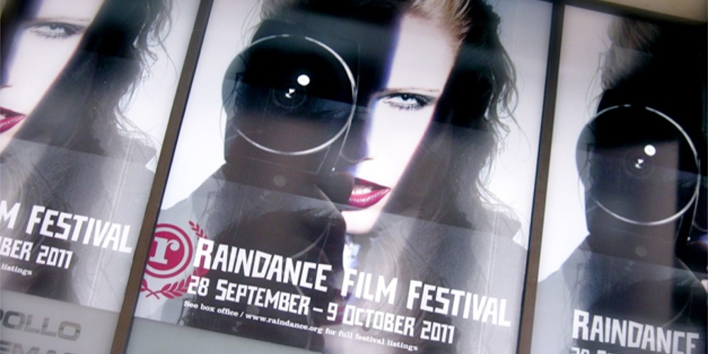 Poster of woman holding a camera for Raindance Film Festival