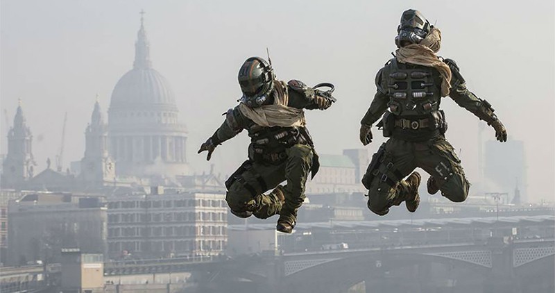 Two men dressed in Halo Masterchief costumes jumping with London landmarks in background