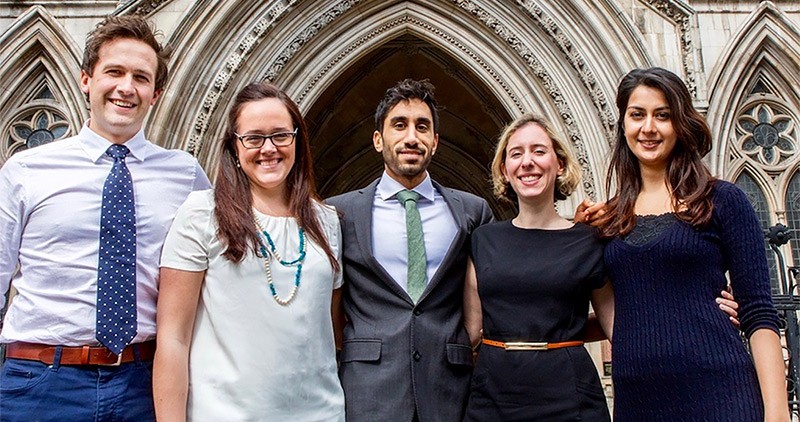 Five Junior Doctors standing in a row in front of the Royal Courts of Justice