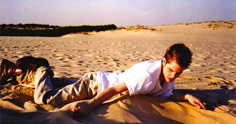 Matt Shepard lying on a beach