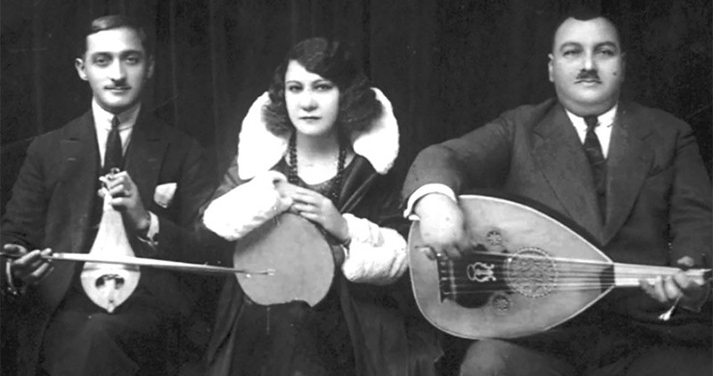 ‘Greek Blues’ singer Roza Eskenazi holding tambourine with two musicians either side